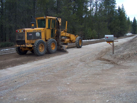0326 - Our associations grader leveling the road